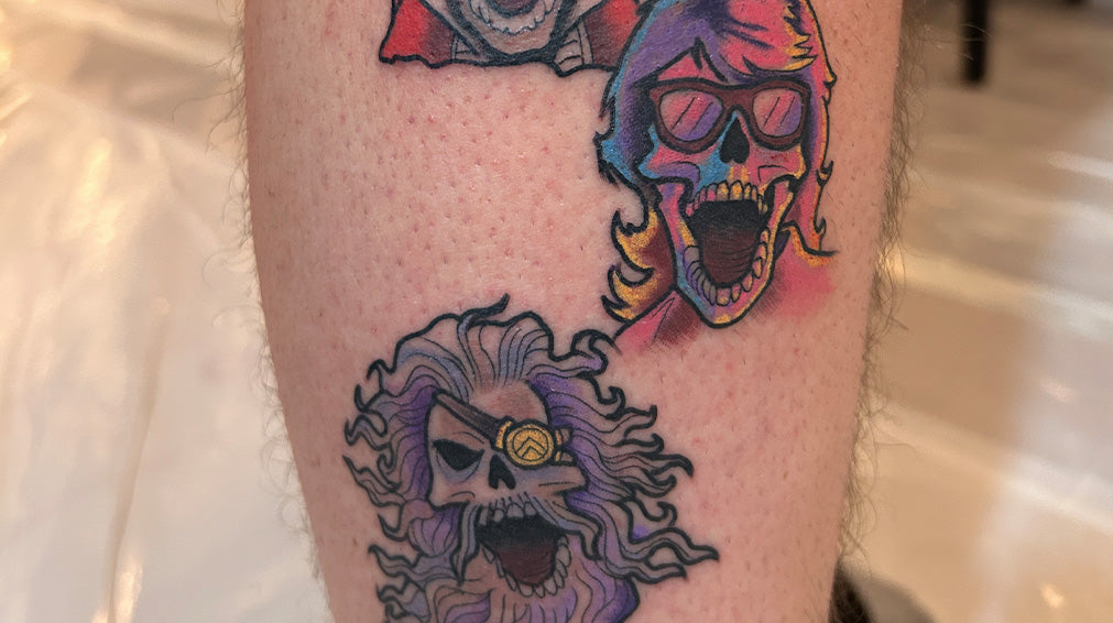 Tattoo of multiple ShipRocked logos including long hair and beard plus multicolored with glasses