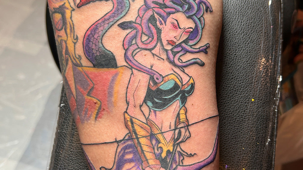 Tattoo of Medusa holding a bow and arrow