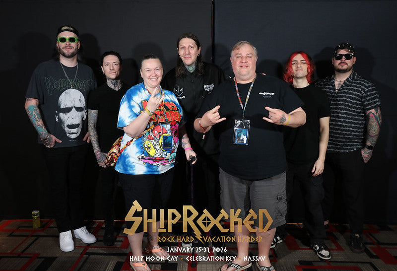 Group of people posing with band members for 'ShipRocked' branded photo p