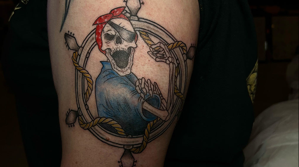 Tattoo of ShipRocked version of We Can Do It!. Skeleton with eye patvh and wearing red bandaana