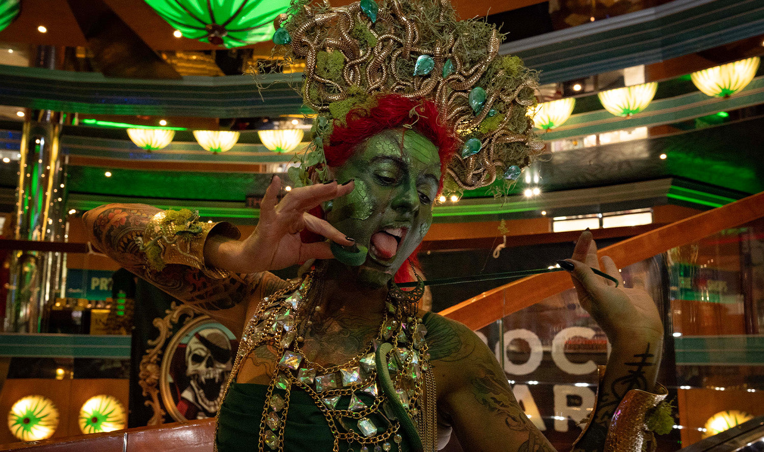 Woman in green face paint with medusa inspired headdress 