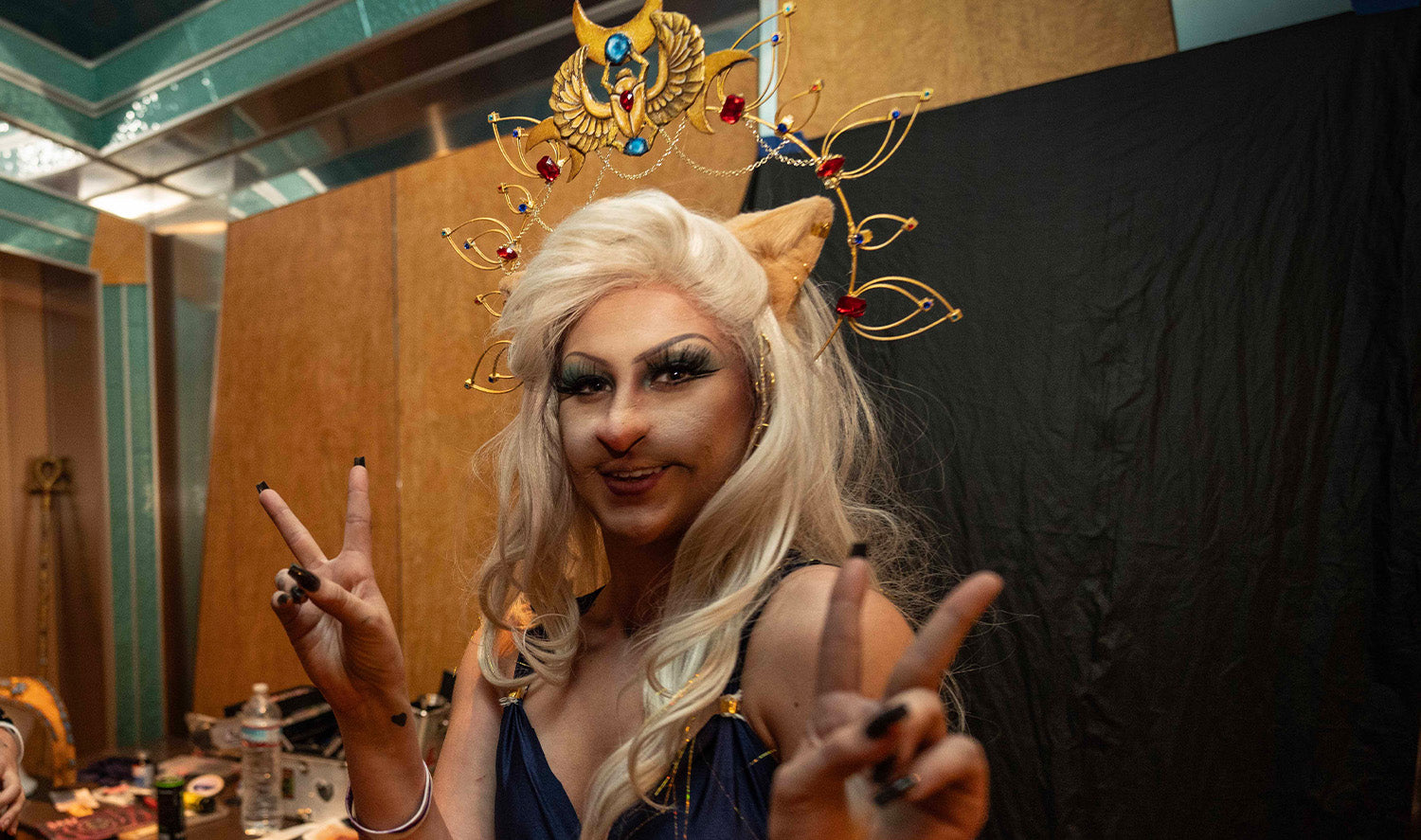 Woman giving peace signs in cat outfit