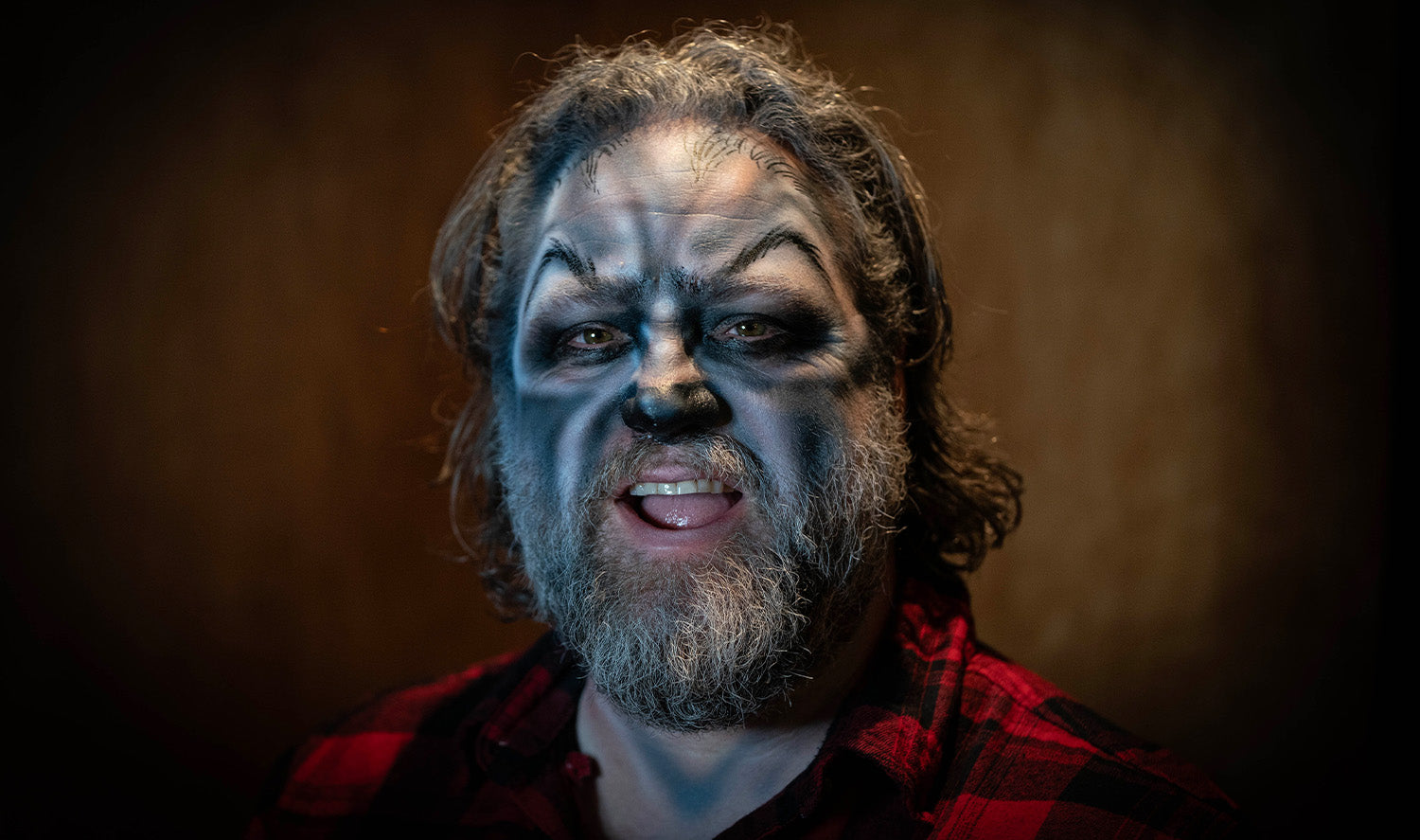 Man with his werewolf makeup and red plaid shirt
